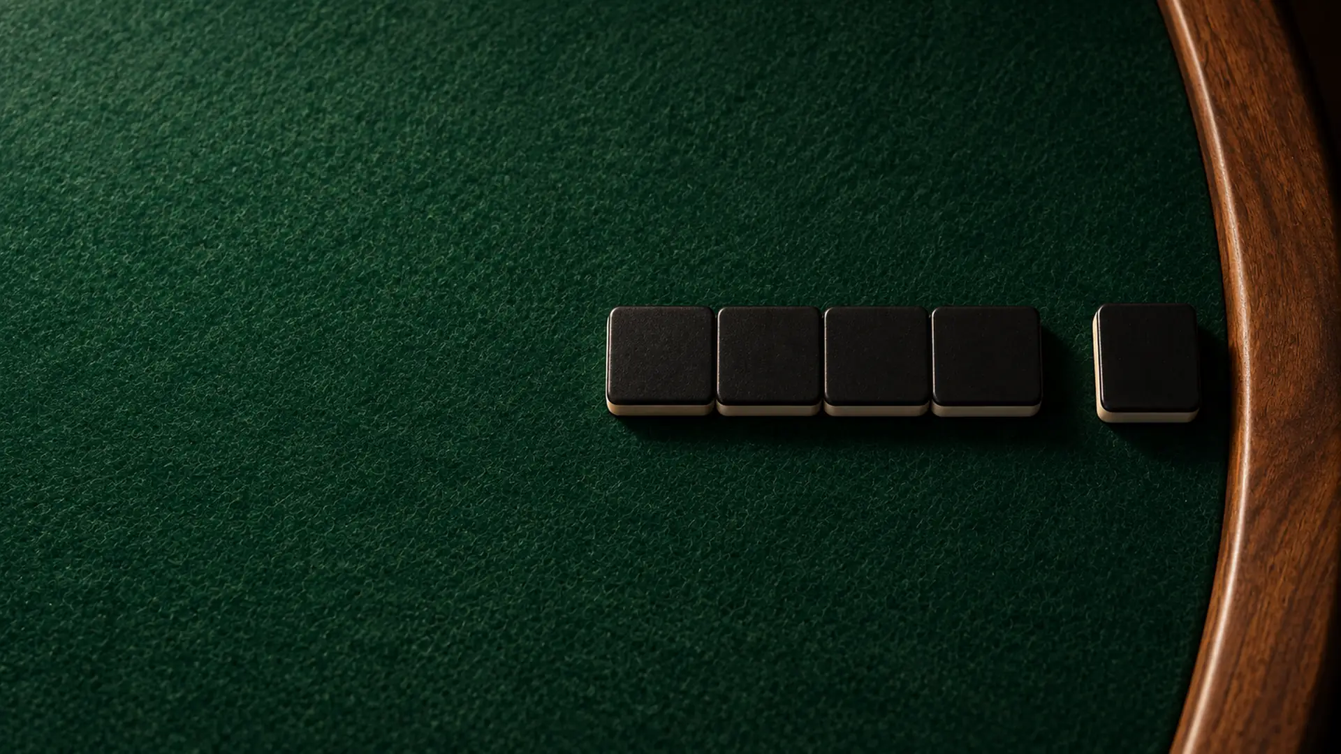 The last dominoes of the line lying face down by the walnut rim